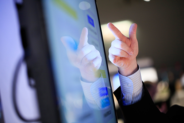 hand-on-video-screen interacting with a video screen